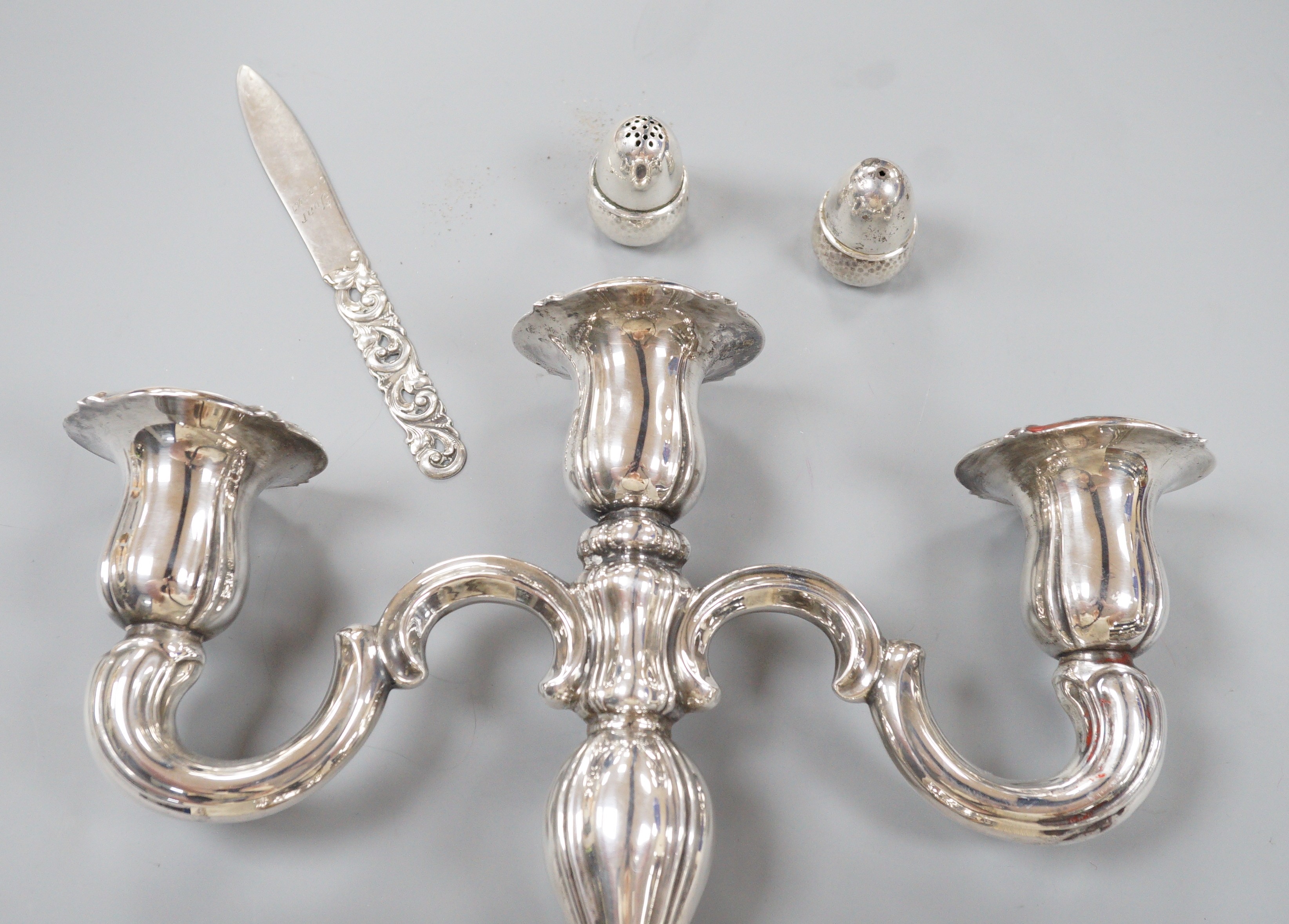 A 20th century Danish 830 standard white metal candelabrum, height 25.6cm, weighted, a pair of Danish white metal acorn condiments and a Danish white metal paper knife.